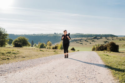 Full length of man standing on landscape against sky