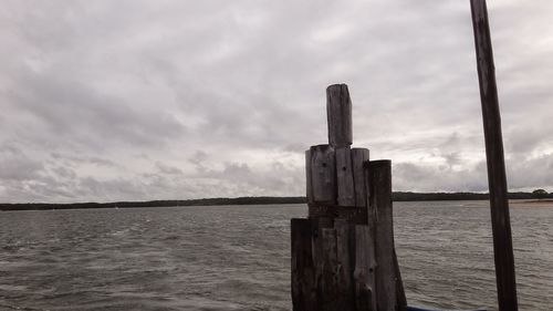 Close-up of wooden post against sea