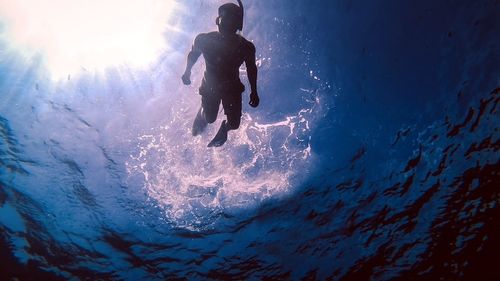 Low angle view of man scuba diving in sea