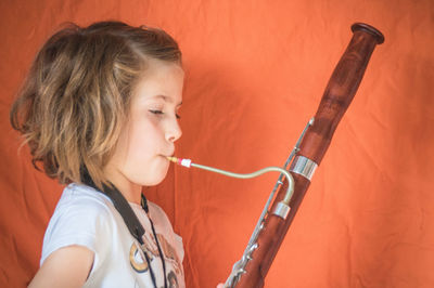 Side view portrait of a girl playing bassoon