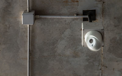 Close-up of electric lamp on wall