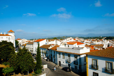 High angle shot of townscape against blue sky