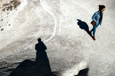 Shadow of man and woman walking on street