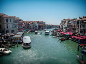 Boats in river with buildings in background