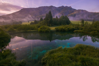 Scenic view of lake and mountains against sky