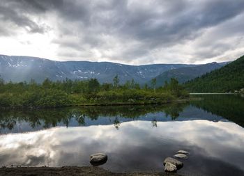Scenic view of lake and mountains against sky