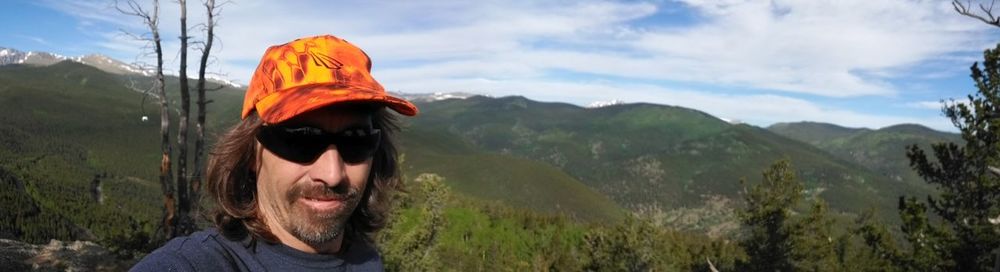 Portrait of woman standing on mountain against sky