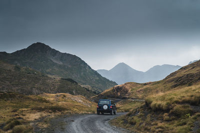 Road amidst mountains against sky