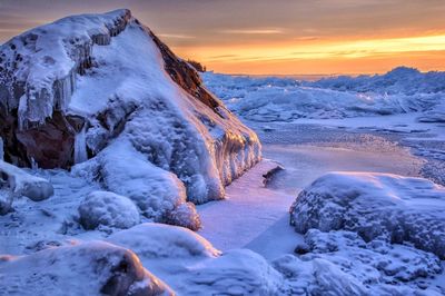 Frozen lake superior against sky during sunrise