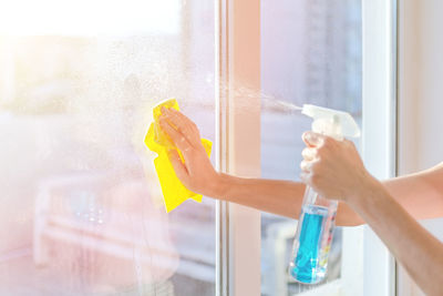 Man holding glass window at home