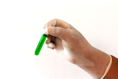 Close-up of hand holding over white background