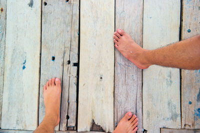 Low section of people on wooden floor