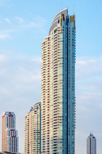 Low angle view of modern buildings against blue sky
