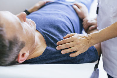 Close-up of doctor comforting patient at hospital