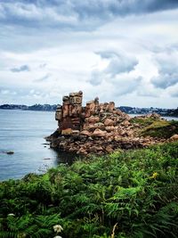 Stack of rocks on land against sky