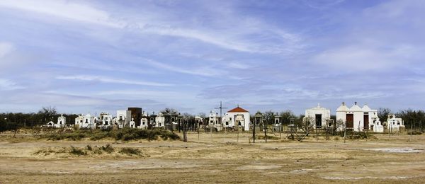 Cemetery alongside the road to tucuman, argentina. arid, sandy. grave monuments painted white.