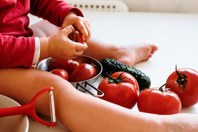 Close-up of girl holding tomatoes