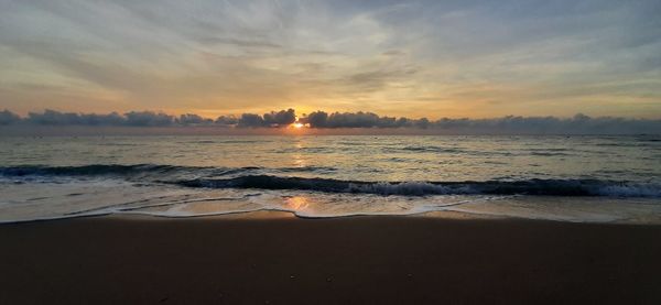 Scenic view of beach against sky during sunset