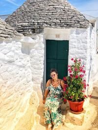 Woman standing by potted plant