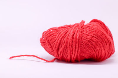 Close-up of red leaf over white background