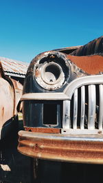 Abandoned truck against clear blue sky old car at scrapyard