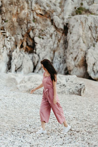 Full length of woman walking on rock