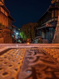 Surface level of street amidst buildings at night