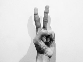 Close-up of human hand against white background