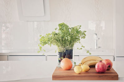 Vegetables and fruits on a clean table, white kitchen with scandinavian style