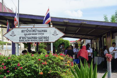 View of people with flowers in front of building