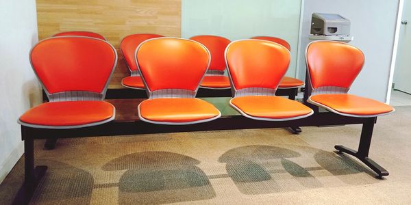 Empty orange chairs side by side
