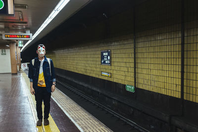 Man standing on railroad station platform