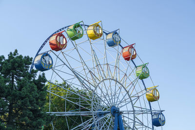 Ferris wheel on a blue sky background