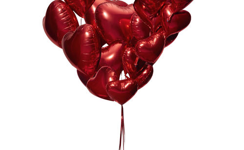 Close-up of heart shape balloon against white background