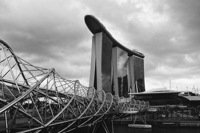 Low angle view of bridge against cloudy sky