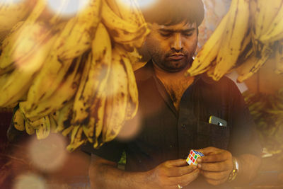 Portrait of man holding mobile phone