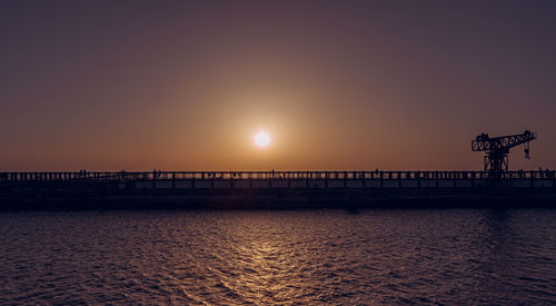 Scenic view of sea against clear sky during sunset