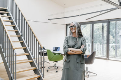 Smiling woman with long grey hair in office