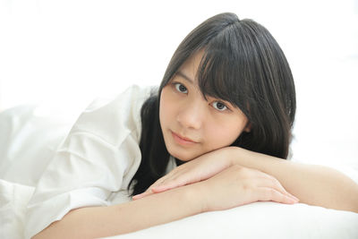 Young woman lying on bed at home