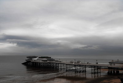 Pier over sea against sky