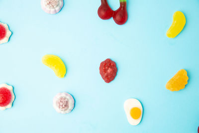 Close-up of multi colored candies against blue background