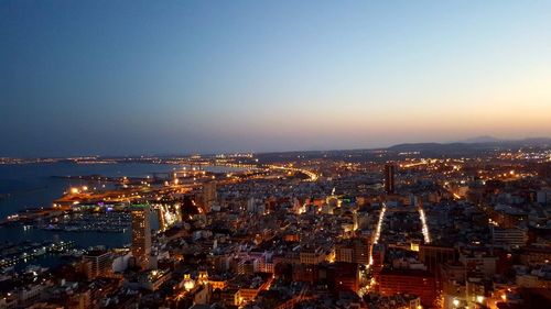 Aerial view of city lit up at night