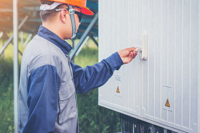 Manual worker opening door with key