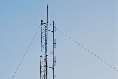 Low angle view of crane against clear sky