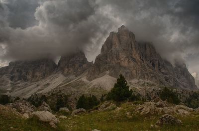 Scenic view of rocky mountains against cloudy sky