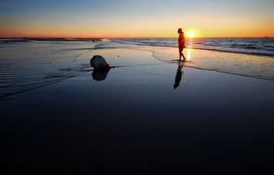 Full length of man on beach during sunset