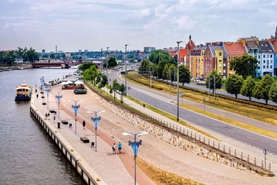 Panoramic view of river amidst buildings in city against sky