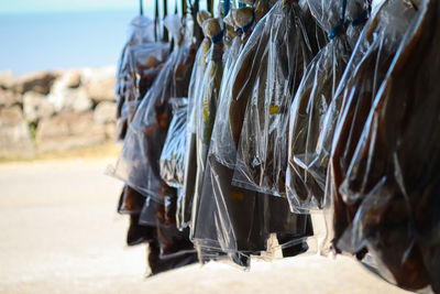 Dried salted fish are hanged to sell in an asian fish market