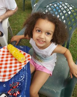 Portrait of happy girl holding baby