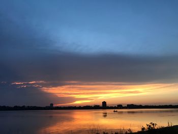 Scenic view of lake against sky during sunset